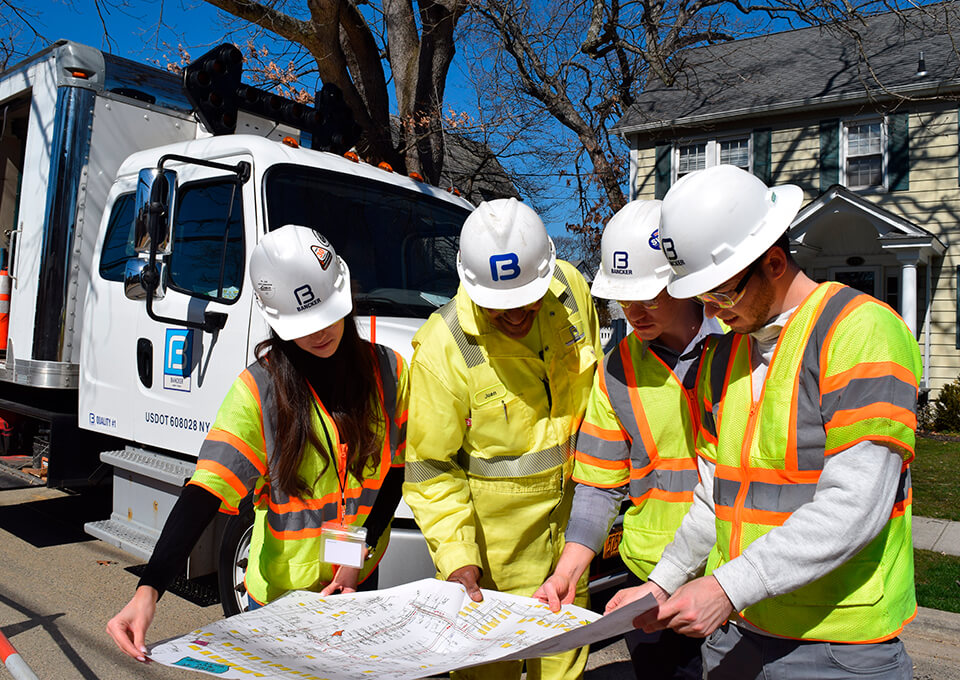 Bancker field and office team reviewing a project plan on site