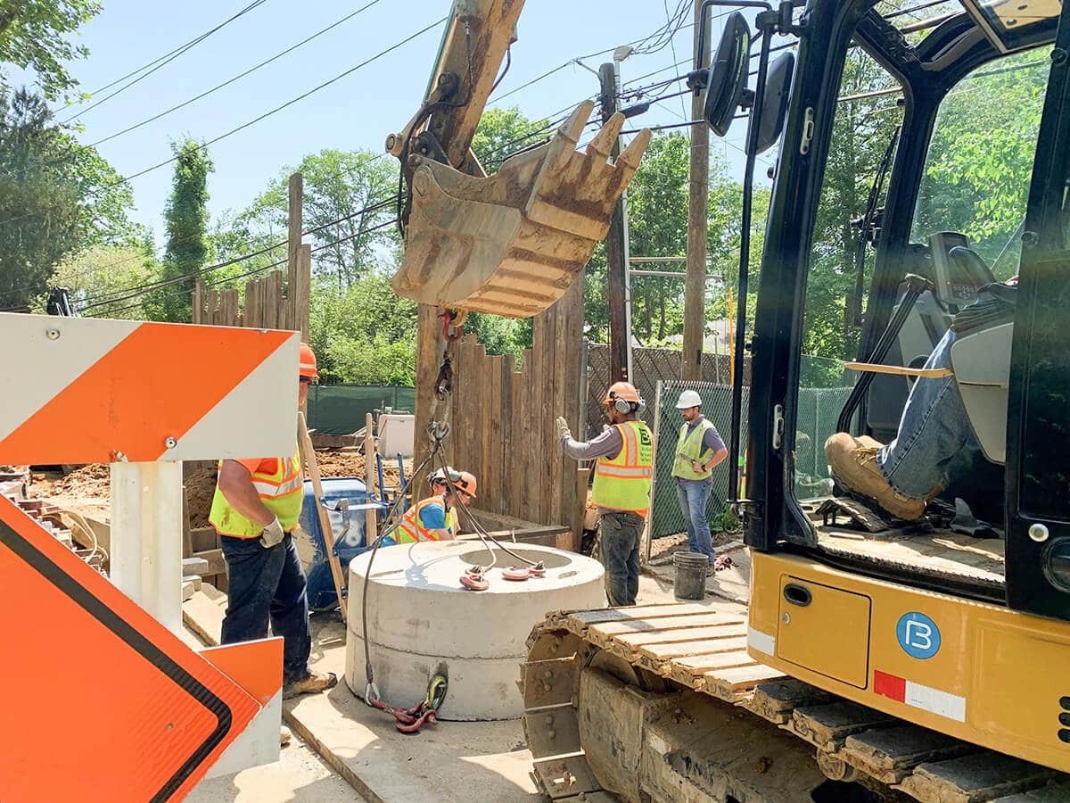Precast manhole structure being set into an excavation
