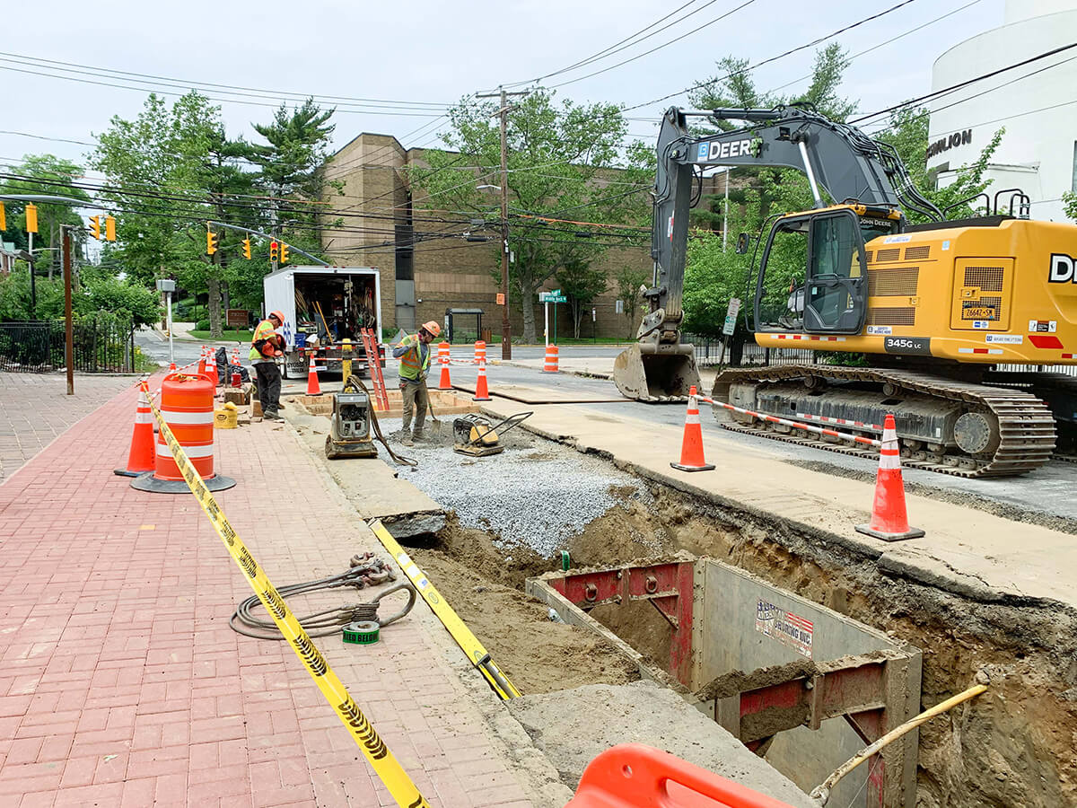 Deep utility trench with steel trench box during a water main replacement project