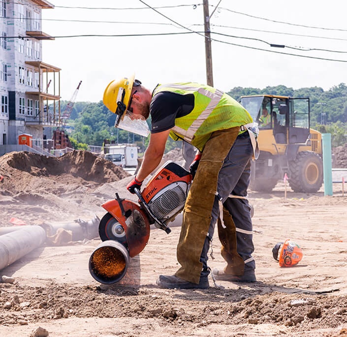 Worker performing pipe fusion on site